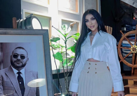 Dounia Batma next to a picture of King Mohammed VI