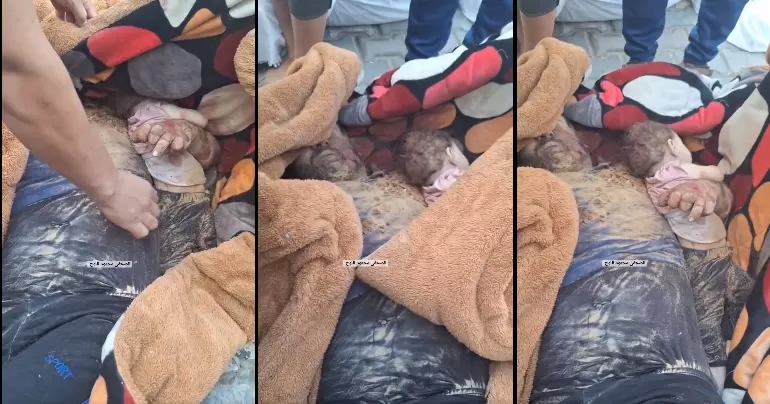 A Palestinian martyr embraces his martyred infant