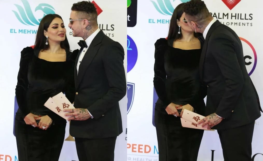 أحمد الفيشاوي وزوجته يثيران الجدل بقبلة حميمة خلال حفل إفتتاح مهرجان القاهرة السينمائي في دورته الـ 43. watanserb.com