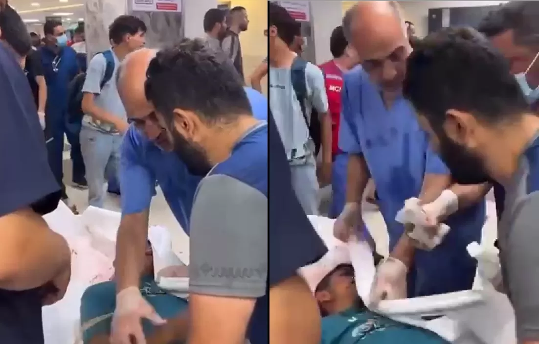 الشاب الفلسطيني برفقة طاقم طبي يحاول إنقاذ شهيد