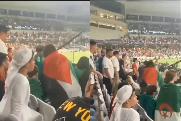 المشجعة الجزائرية تتوشح العلم الفلسطيني وهي تغادر الملعب