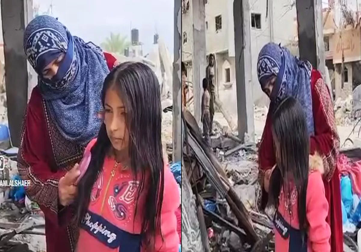 سيدة فلسطينية وطفلتها من فوق ركام منزلها في غزة