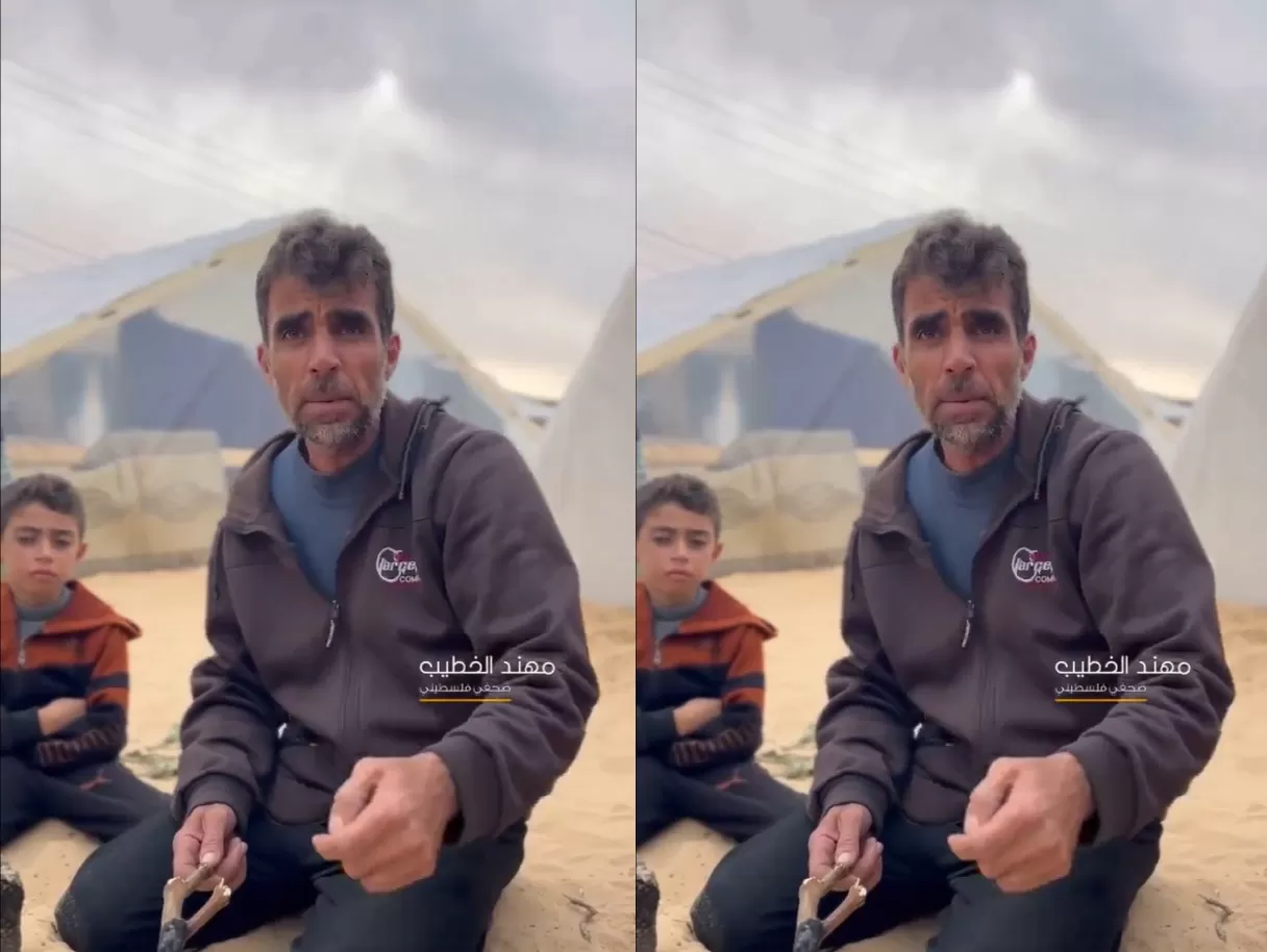 فلسطيني نازح مع ابنه على الحدود المصرية